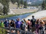 Tourists crowd into the Midway Geyser Basin at Yellowstone National Park in Wyoming on July 14. Yellowstone is one of many national parks seeing record numbers of visitors this summer, even as coronavirus cases are rising in many states.