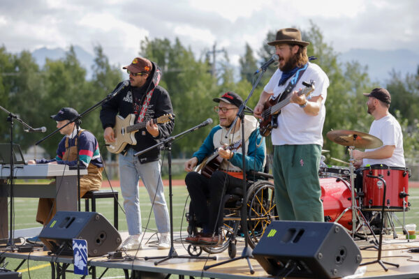 a group of people perform music on stage on a football field