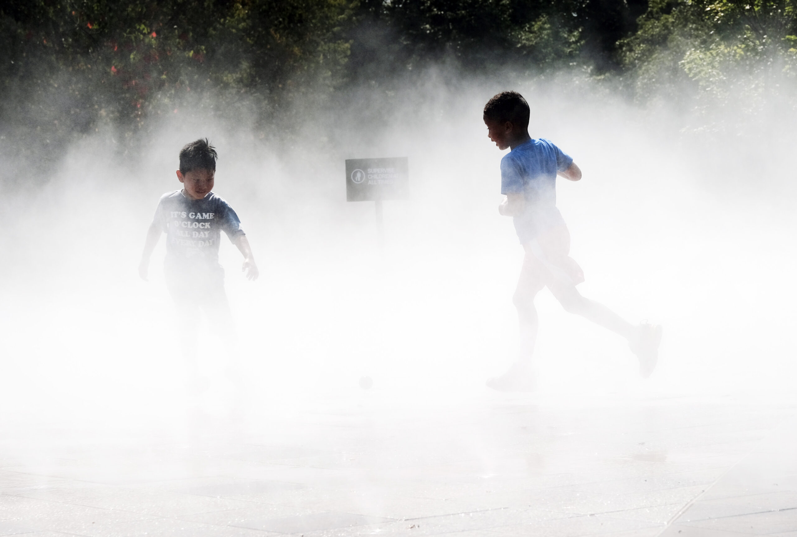 Children play in a misty water.