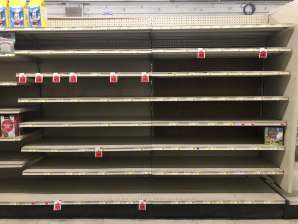 Several empty shelves at a grocery store.