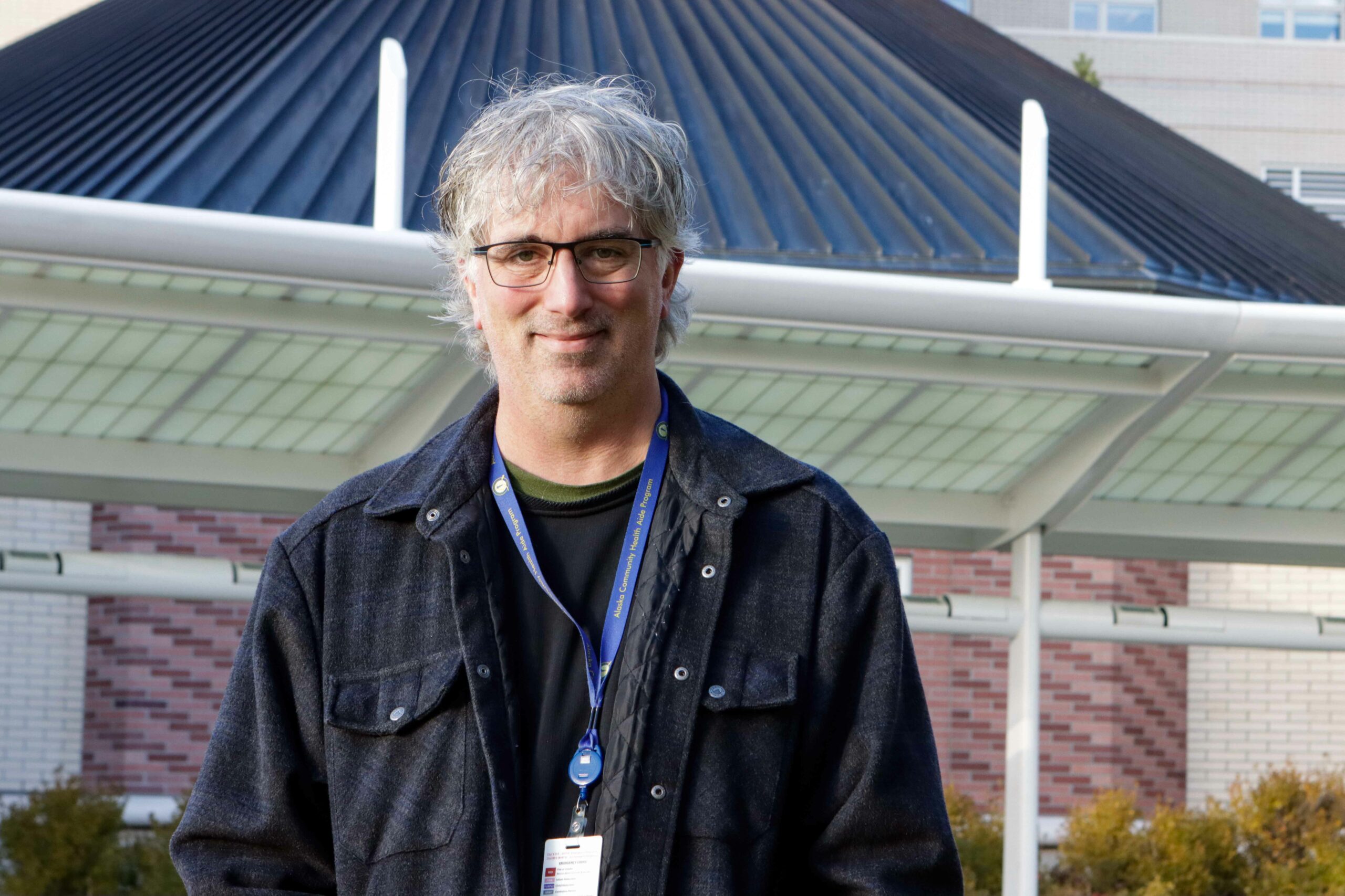 Dr. Matt Hirschfeld poses in front of the Alaska Native Medical Center