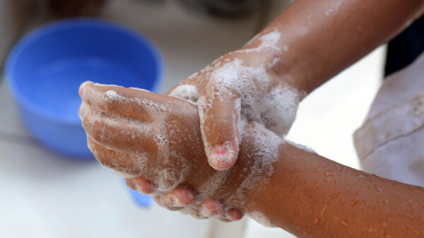 A close-up image of someone washing their hands.