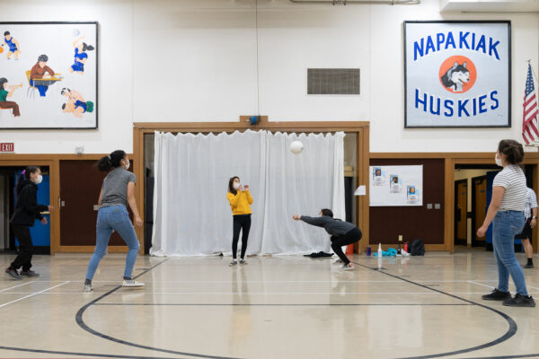 Students play in a school gym.