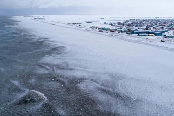 A community on the edge of a frozen ocean.