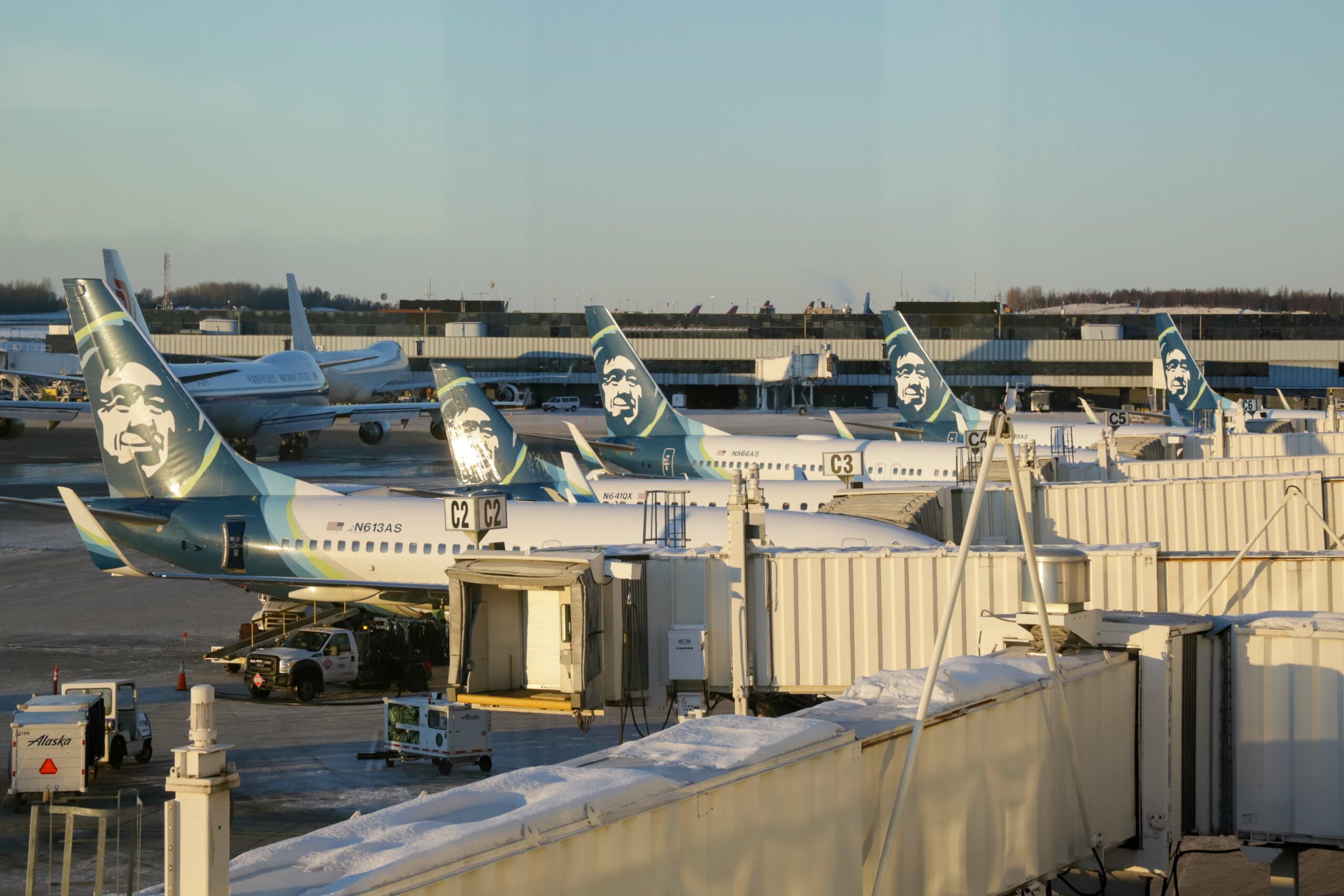 Five Alaska Airlines planes parked at the gate