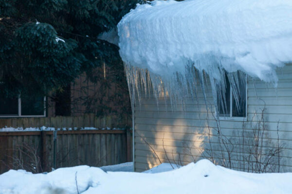 Big icicles hang off a roof.
