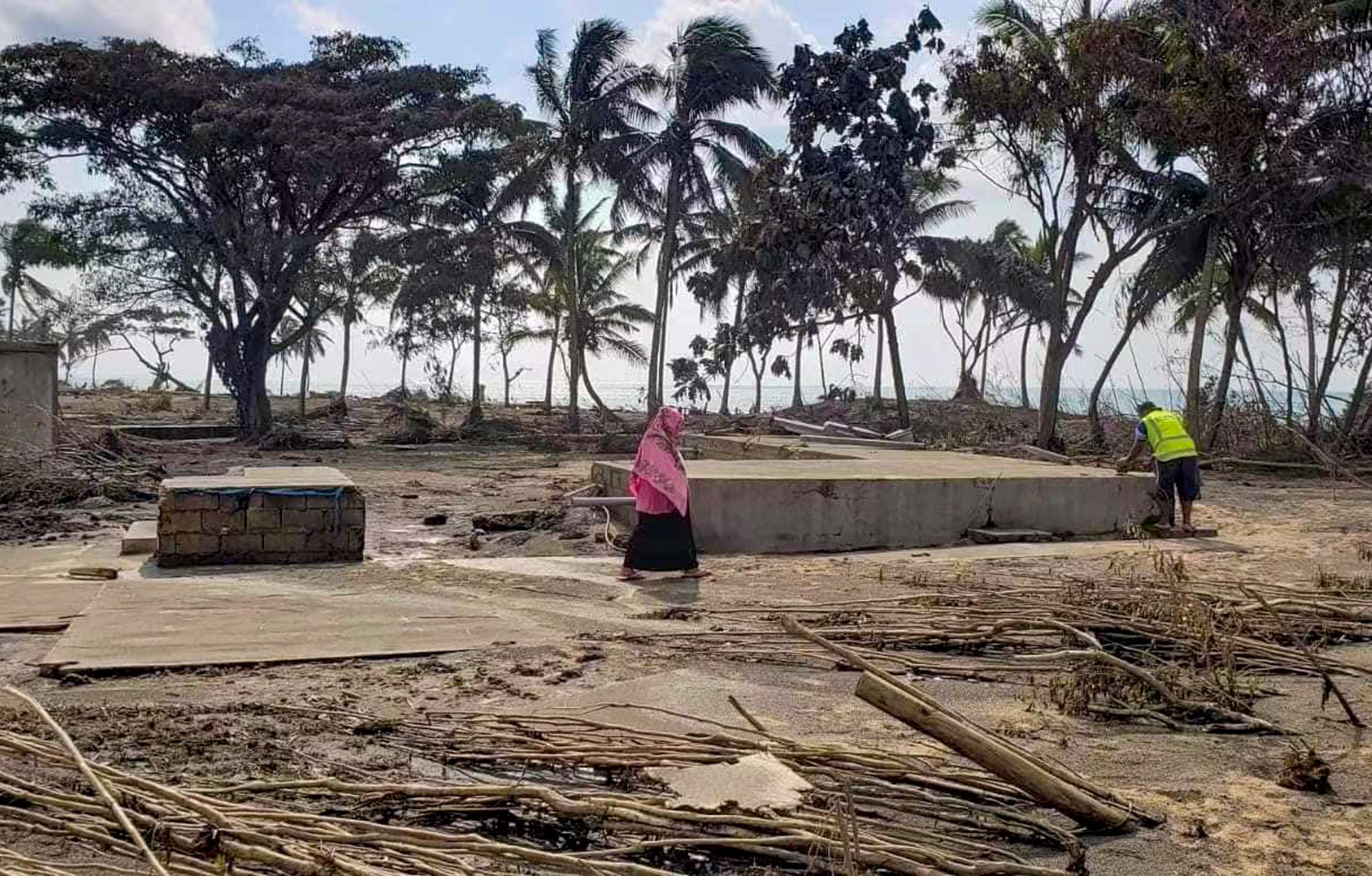 A person stands on a beach resort, wrecked by a tsunami