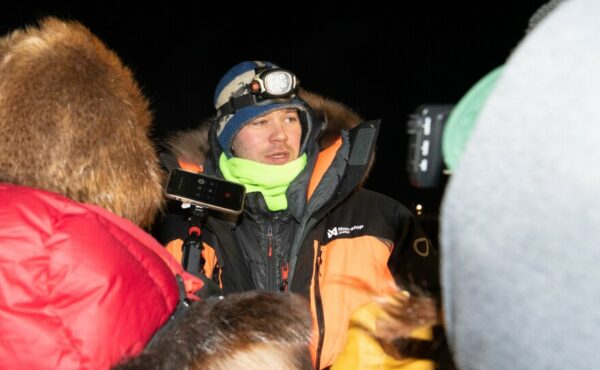 A musher talks to reporters
