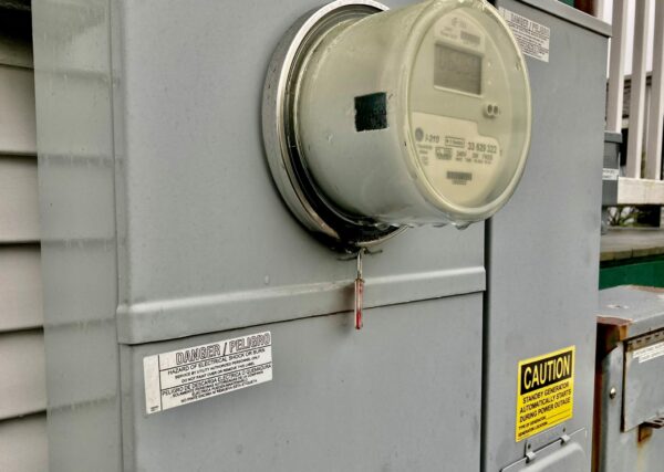 A photo of an electric meter on the side of a building
