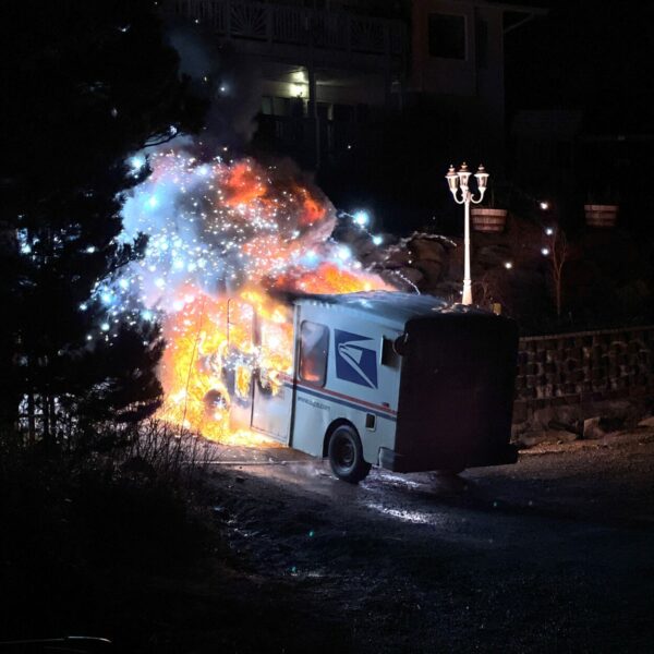 A postal service truck goes up in flames