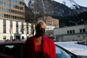 A woman standing outside wearing a mask