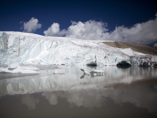 the edge of a glacier meeting a glacial lake