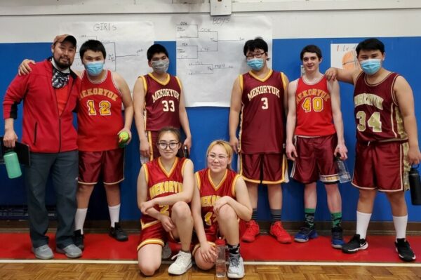 A team photo of a coed high school basketball team