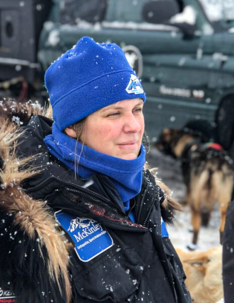 A woman with a blue hat and a black furruffed parka