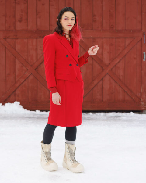 A woman in a red jacket and bunny boots