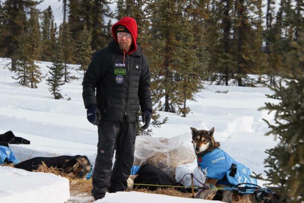 A musher near his dogs