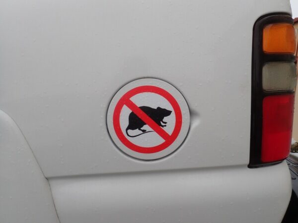 A magnet on the side of a truck with a rat crossed out