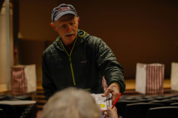 a person receives a ballot from an election worker
