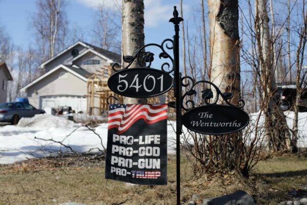 driveway sign that says pro life, pro god, pro gun, pro Trump.