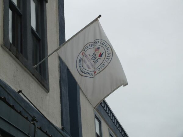 A white flag flying from the side of a building