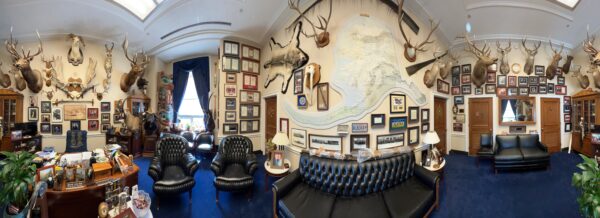 Panorama of office with lots of animal heads on the wall