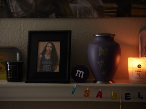 a photo next to an urn on a mantel