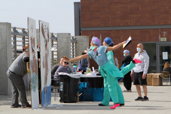 Healthcare workers throwing pies at the carnival for nurses week.