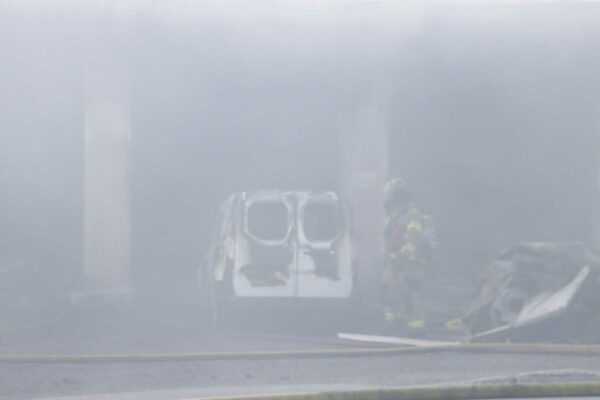 heavy smoke with a firefighter and truck faintly visible