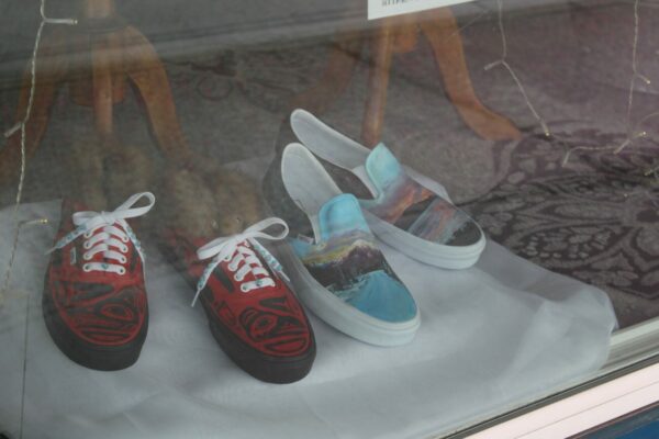 two pairs of shoes in a store window