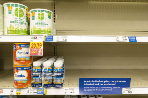 Shelves that are mostly empty but have some baby formula on them