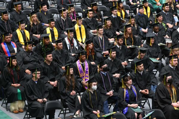 students sit at a graduation