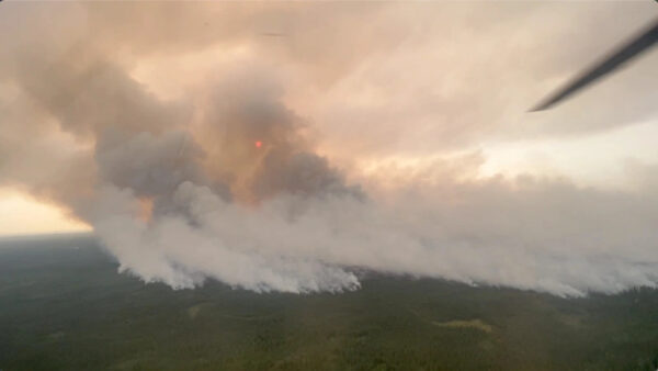 smoke billows from a wildland fire