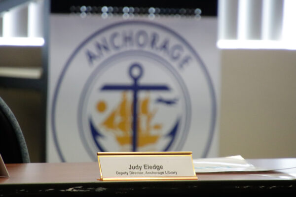A placard that says Judy Eledge in front of a Municipality logo