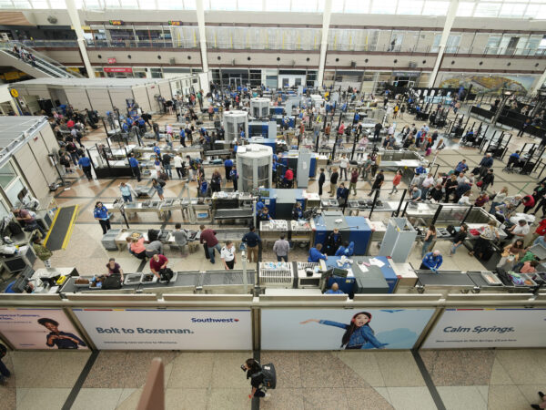 crowds of people going through TSA in an airport