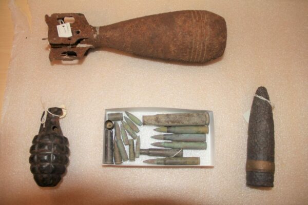 Grenades and weapons laid out on a table