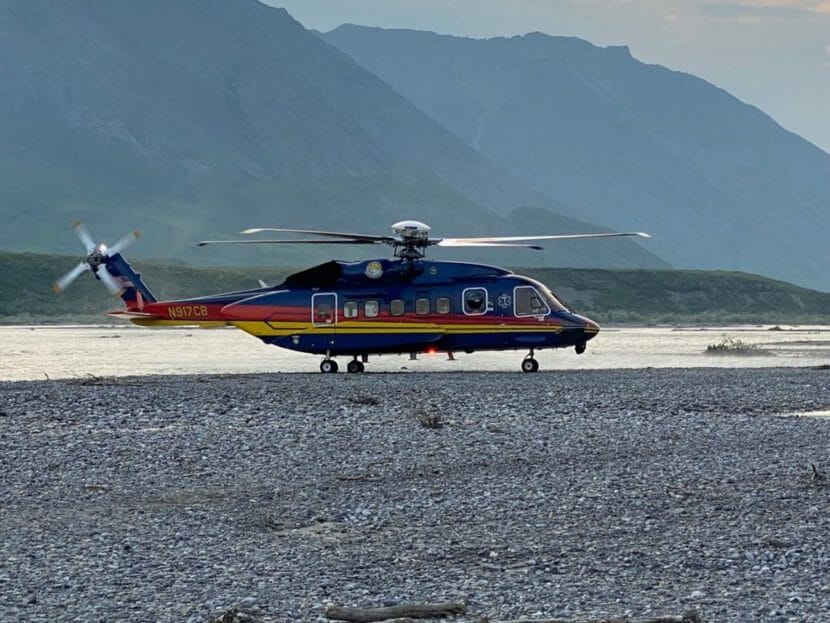 a helicopter in front of mountains