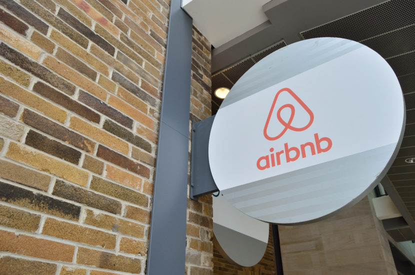 A sign with the Airbnb logo.
