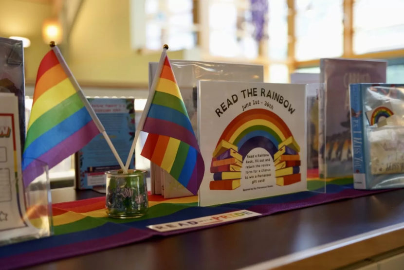 A rainbow display of books at a public library.