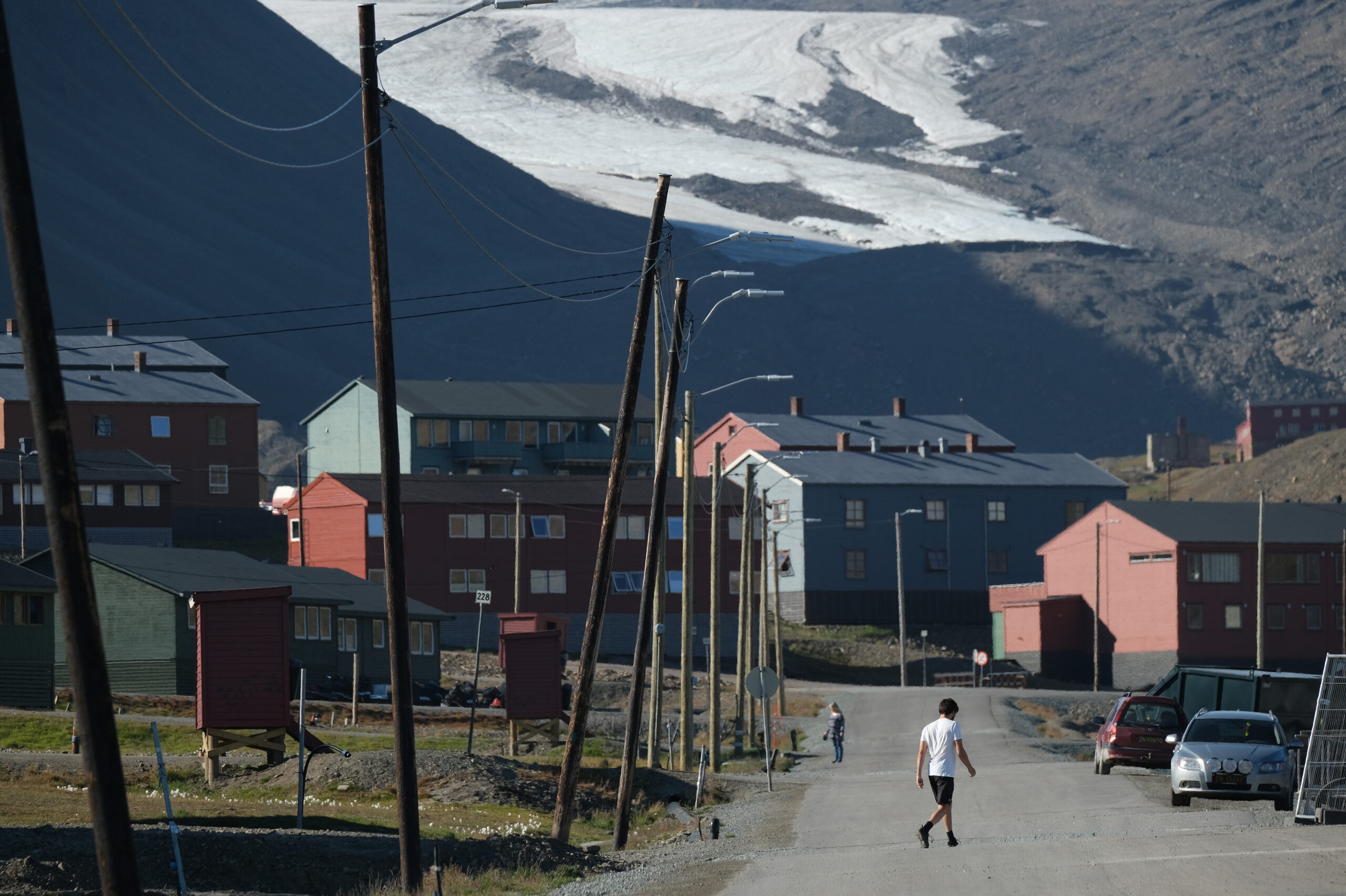a view of a street in a community that sits in front of a mountain and glacier
