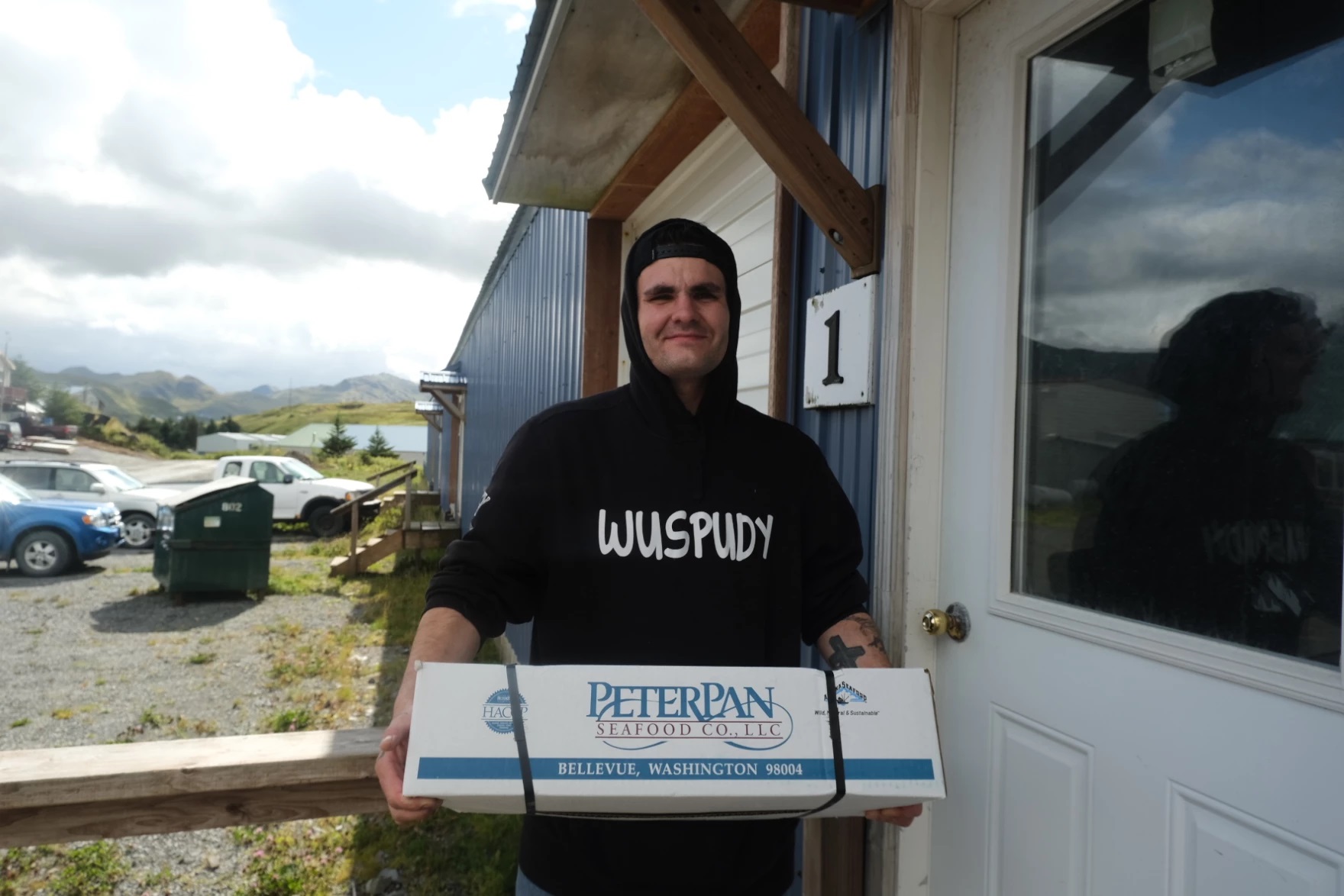 a man holding a seafood box