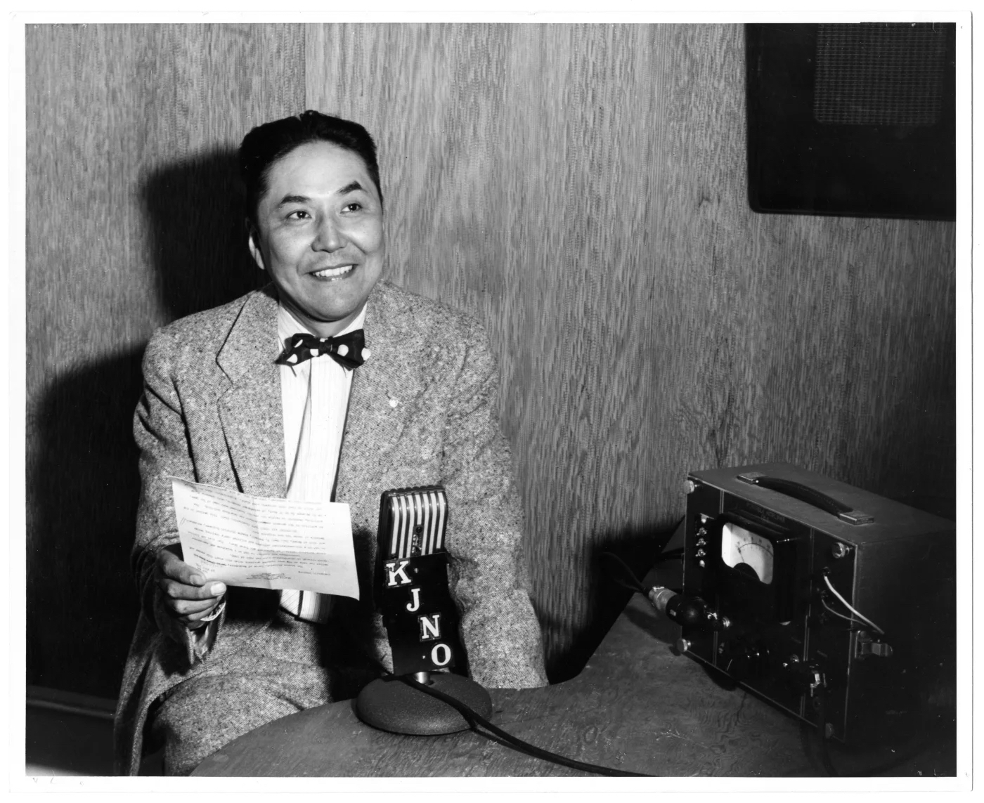 a black and white photo of a man preparing to go on the radio