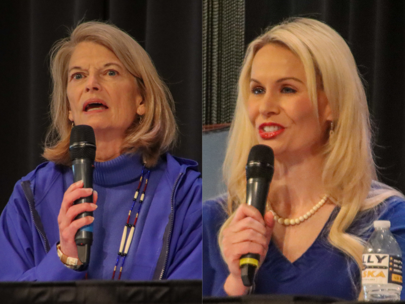 two women in blue shirts talk into a microphone