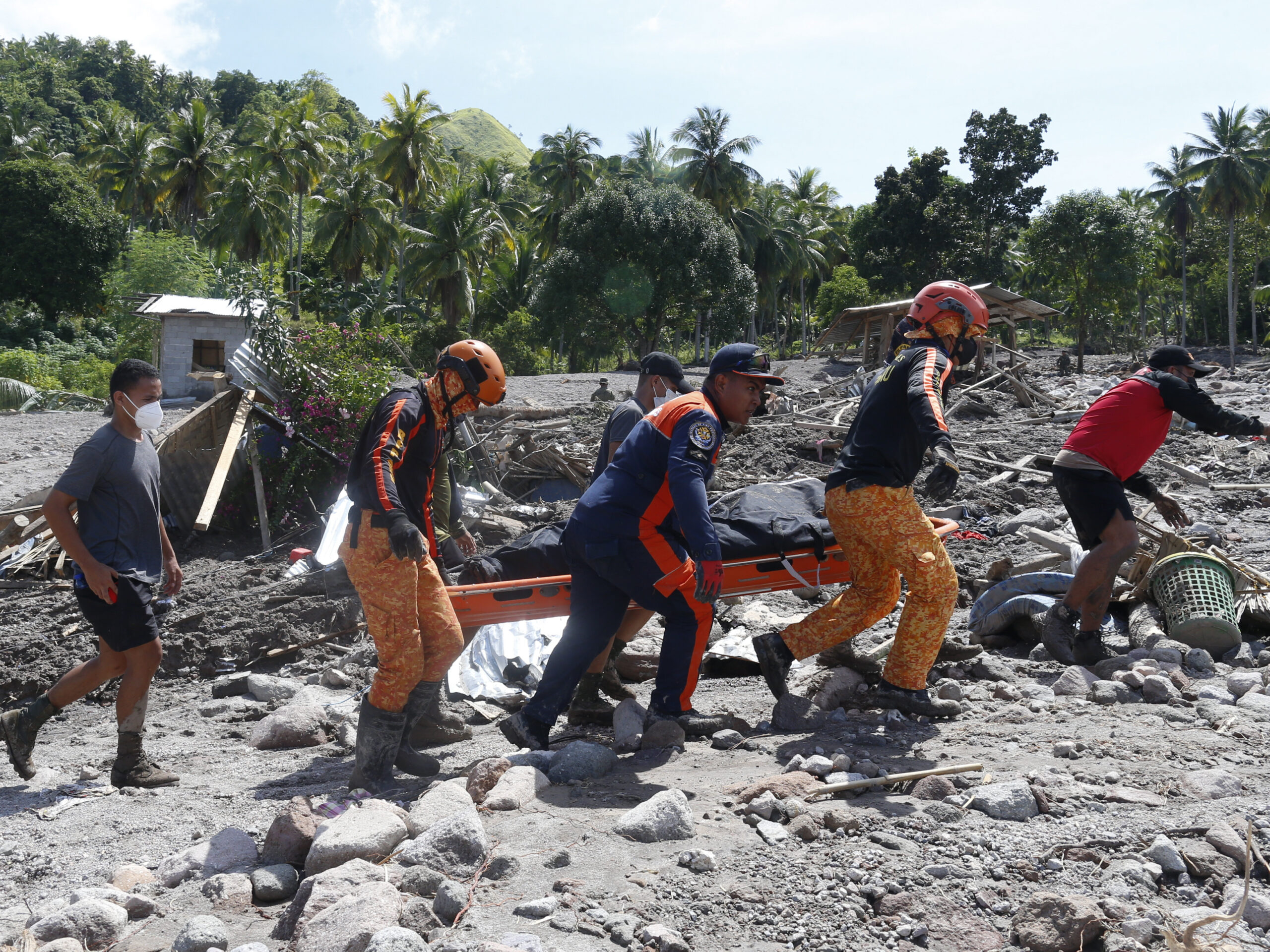 rescuers carrying a body