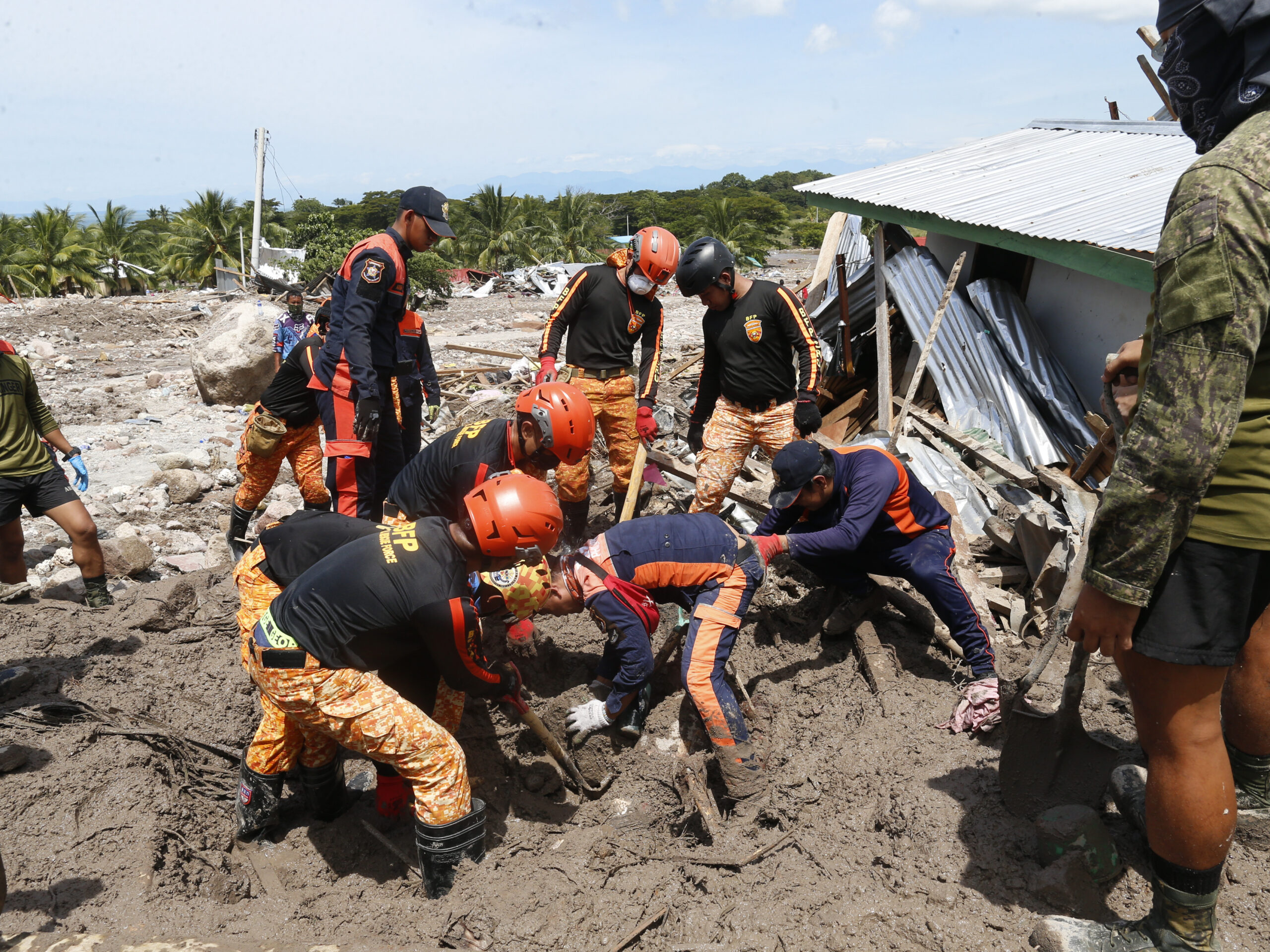 rescuers digging in mud