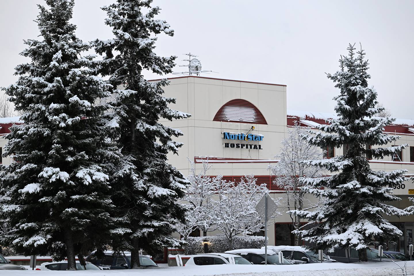a large building surrounded by snowy treees