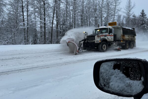 a snow plow clears the road
