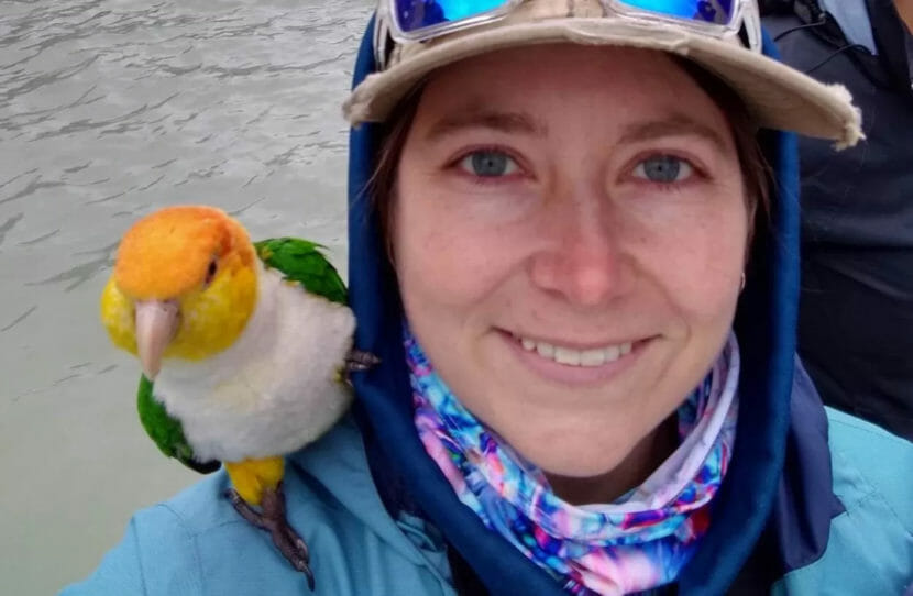 a woman and a parrot