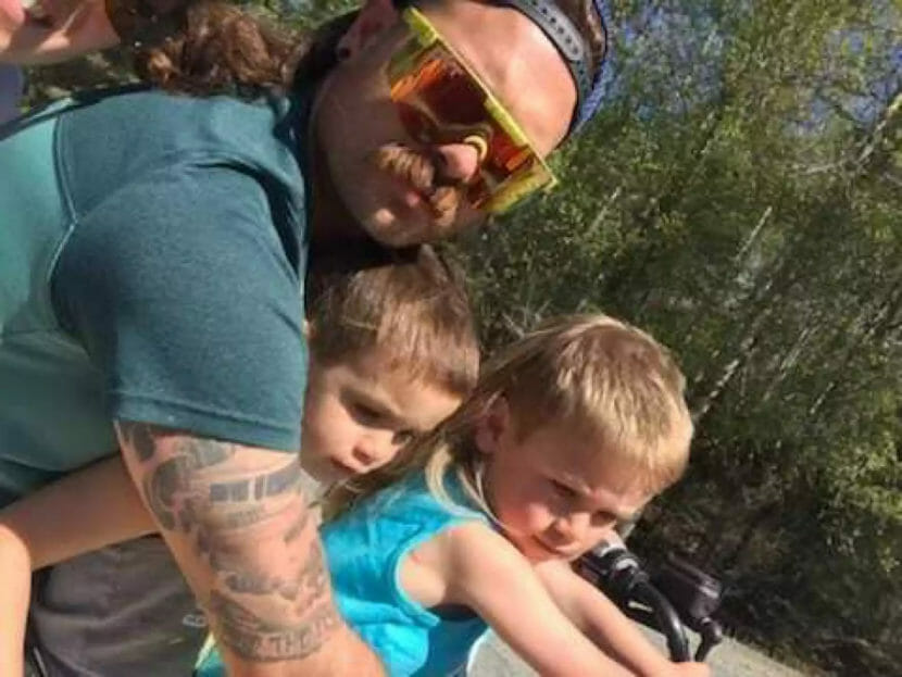 a man and two kids on a motorcycle