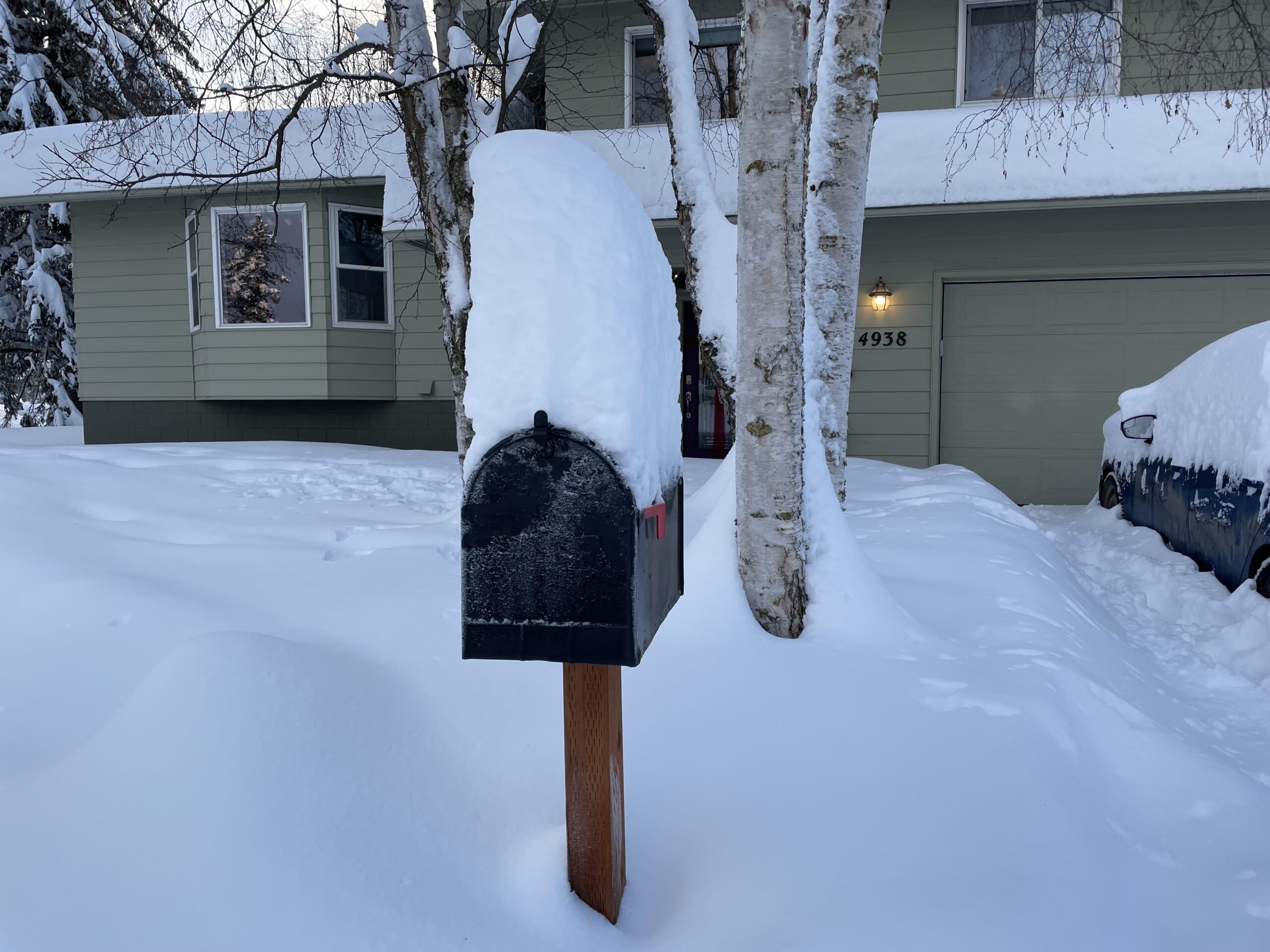 About a foot of snow piles up on a mailbox in Anchorage