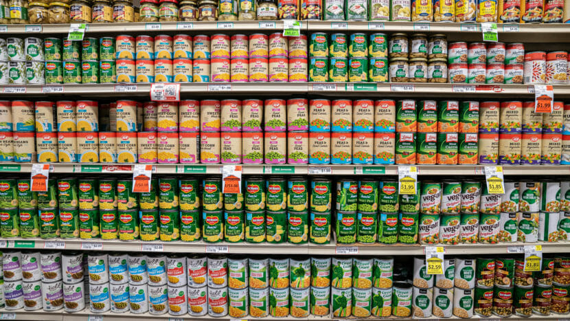 Cans on shelves in a grocery store